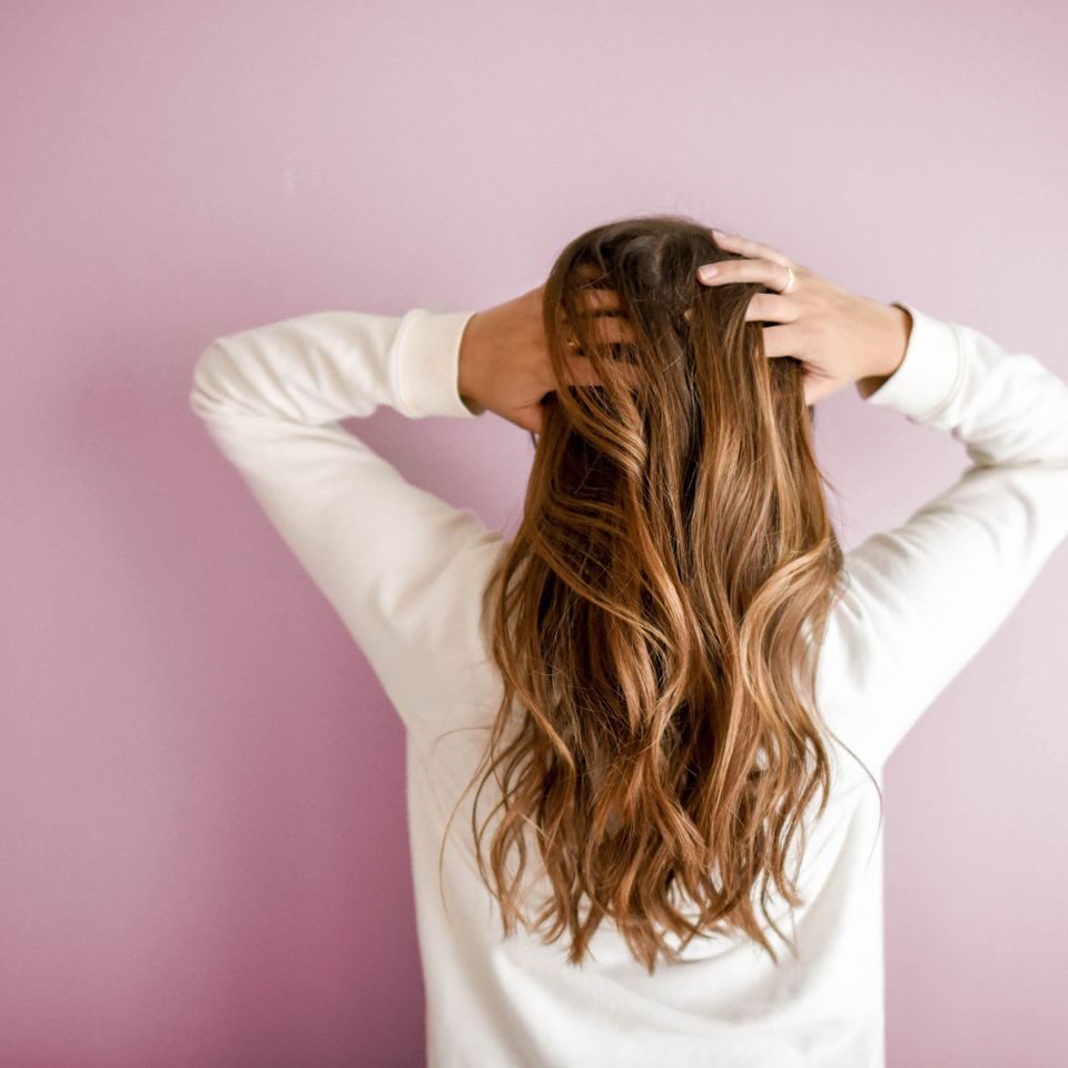 Long, freshly colored hair styled at AA'S Salon